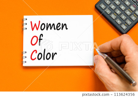 WOC women of color symbol. Concept words WOC women of color on beautiful white note. Beautiful orange background. Businessman hand. Business WOC women of color social issues concept. Copy space. WOC women of color symbol. Concept words WOC women of color on beautiful white note. Beautiful orange background. Businessman hand. Business WOC women of color social issues concept. Copy space. 113624356