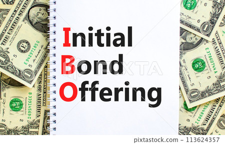 IBO initial bond offering symbol. Concept words IBO initial bond offering on beautiful white note. Beautiful dollar bills background. Business IBO initial bond offering concept. Copy space. 113624357