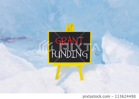 Grant funding symbol. Concept words Grant funding on beautiful yellow black blackboard. Beautiful blue ice background. Business and grant funding concept. Copy space. Grant funding symbol. Concept words Grant funding on beautiful yellow black blackboard. Beautiful blue ice background. Business and grant funding concept. Copy space. 113624498