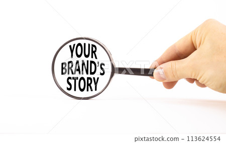 Branding and your brand story symbol. Concept words Your brands story in magnifying glass. Beautiful white background. Businessman hand. Business branding your brand story concept. Copy space. 113624554