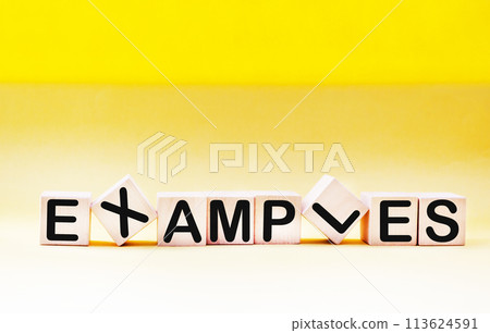 Examples of words written on a wooden block. Examples of text on a yellow background Examples of words written on a wooden block. Examples of text on a yellow background 113624591