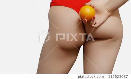 Young woman holding orange on light background Young woman holding orange on light background 113625087