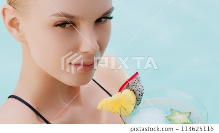 Blonde woman drinks refreshing cocktail sunbathing Blonde woman drinks refreshing cocktail sunbathing 113625116