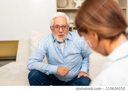 Female doctor examining older senior man in doctor office or at home. Old man patient and doctor have consultation in hospital room. Medicine healthcare medical checkup. Visit to doctor 113626358