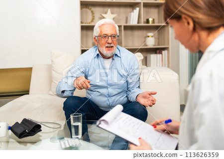 Female doctor examining older senior man in doctor office or at home. Old man patient and doctor have consultation in hospital room. Medicine healthcare medical checkup. Visit to doctor Female doctor examining older senior man in doctor office or at home. Old man patient and doctor have consultation in hospital room. Medicine healthcare medical checkup. Visit to doctor 113626359