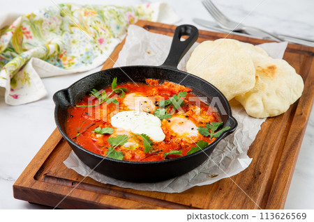 beetroot borscht with sour cream and parsley in a frying pan, side view beetroot borscht with sour cream and parsley in a frying pan, side view 113626569