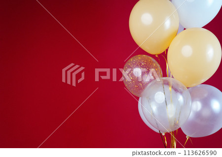 Light balloons - white, beige, transparent, pearl on a red background. Horizontal photo. Space for text Light balloons - white, beige, transparent, pearl on a red background. Horizontal photo. Space for text 113626590