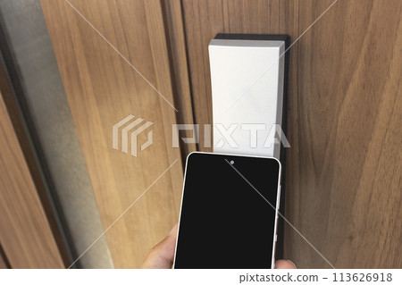 Image of unlocking the door with a smartphone Image of unlocking the door with a smartphone 113626918