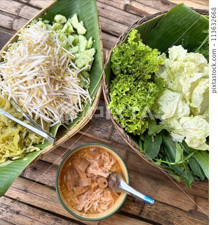Fresh and healthy Thai food with garden vegetables on a wooden table 113632668