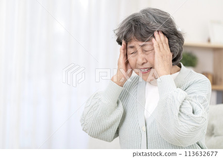 Senior woman with a painful headache Senior woman with a painful headache 113632677