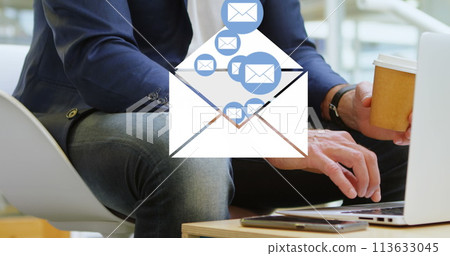 Digital composite of a man checking his emails while drinking coffee with an envelope filled with em 113633045