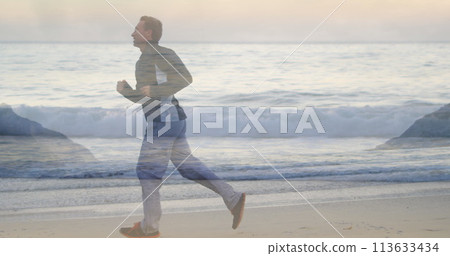 Man running on beach with waves in view 113633434