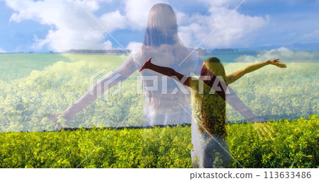 Woman in a yellow flower field with open arms 113633486