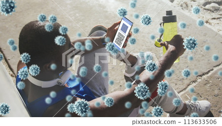Composition of covid-19 cells over african american man using smartphone with qr code on screen Composition of covid-19 cells over african american man using smartphone with qr code on screen 113633506