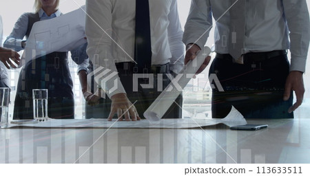 Architects discuss a building plan with graphs 113633511