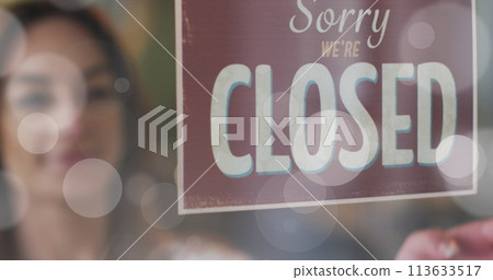Image of light spots over caucasian woman opening shop Image of light spots over caucasian woman opening shop 113633517