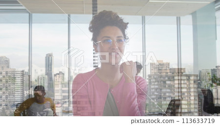 Image of cityscape over diverse business people in office 113633719