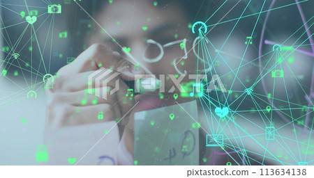 Image of data processing over biracial businessman taking notes on glass wall 113634138