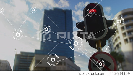Image of network of conncetions with icons over traffic lights and cityscape 113634309