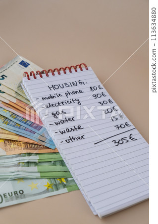Counting expenses bills on housing electricity, gas, water. Banknotes of euro cash around. High prices for energy inflation crisis. Cut back on spending 113634880