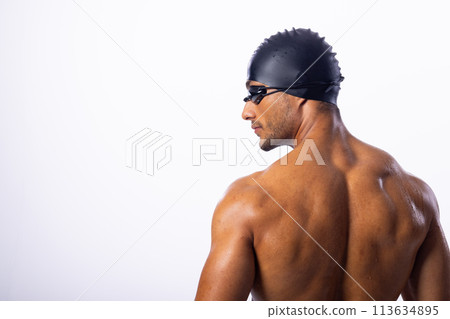 Young biracial male swimmer wearing swimming goggles 113634895