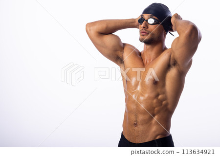 Athletic young biracial male swimmer poses confidently 113634921