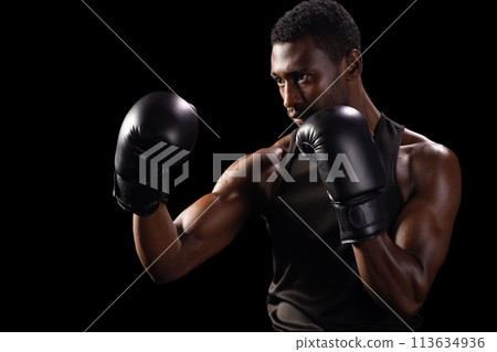 African American man in a boxing stance, with copy space African American man in a boxing stance, with copy space 113634936