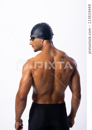 Athletic biracial male swimmer poses confidently Athletic biracial male swimmer poses confidently 113634949