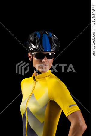 Young Caucasian female cyclist dressed in cycling gear poses confidently Young Caucasian female cyclist dressed in cycling gear poses confidently 113634977