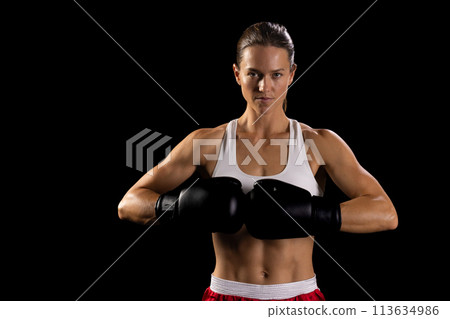 Young Caucasian woman poses confidently in boxing gear, with copy space Young Caucasian woman poses confidently in boxing gear, with copy space 113634986