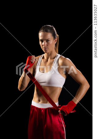 Young Caucasian woman poses confidently in boxing gear, with copy space 113635027