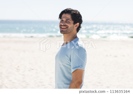 Young biracial man enjoys a sunny day at the beach Young biracial man enjoys a sunny day at the beach 113635164