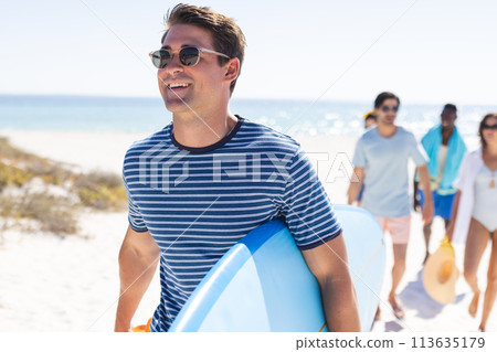 Young Caucasian man enjoys a sunny beach day Young Caucasian man enjoys a sunny beach day 113635179