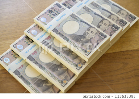 A stack of bills on a desk 113635395