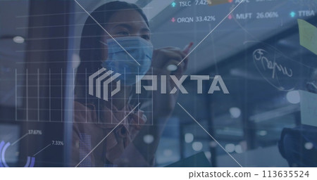 Image of financial data processing over asian businesswoman with face mask taking notes 113635524