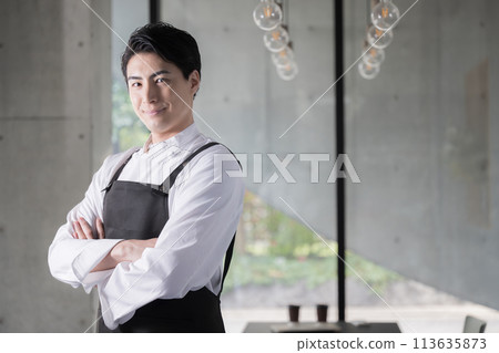 Image of a chef wearing an apron or a man working in the food service industry with his arms crossed; also good for job changes and recruitment 113635873