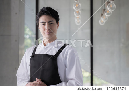 Image of a chef wearing an apron or a man working in the food service industry - also useful for job changes and recruitment Image of a chef wearing an apron or a man working in the food service industry - also useful for job changes and recruitment 113635874