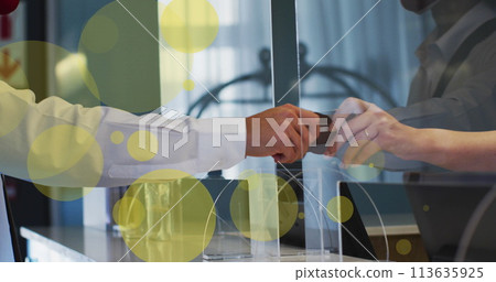 Image of spots over biracial man giving credit card 113635925