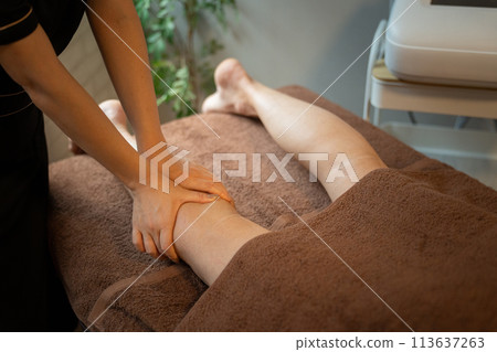 Reflexology, foot massage, leg massage, man getting leg massage at men's beauty salon Reflexology, foot massage, leg massage, man getting leg massage at men's beauty salon 113637263