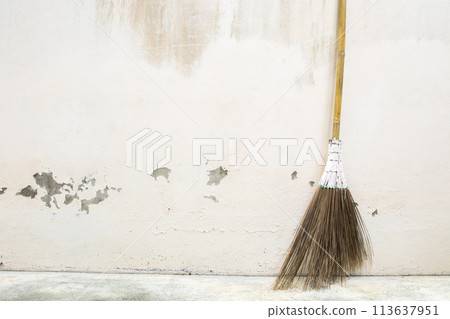 broom for cleaning work at home beside old cement walls broom for cleaning work at home beside old cement walls 113637951