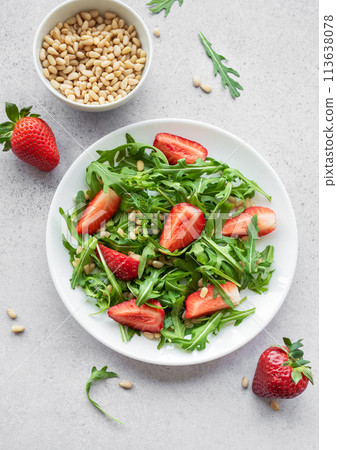 Fresh Strawberry Arugula Salad With Pine Nuts Served on a Bright Day Fresh Strawberry Arugula Salad With Pine Nuts Served on a Bright Day 113638078