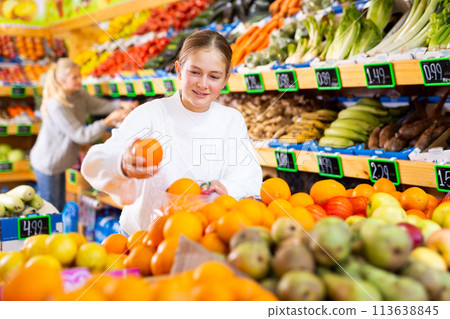 Portrait of teenage girl customer buying sweet oranges at shop Portrait of teenage girl customer buying sweet oranges at shop 113638845