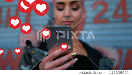 Image of falling social media icons over women using smartphone 113639031