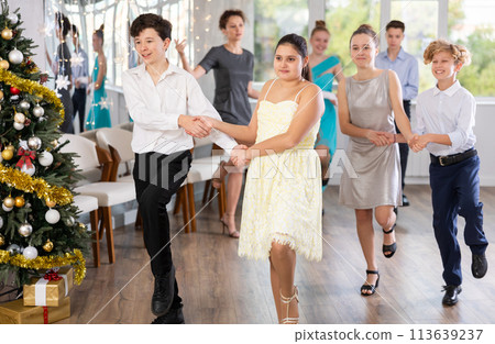 Teen boy and girl dancing modern discofox in couple during lesson at studio in New Year atmosphere 113639237