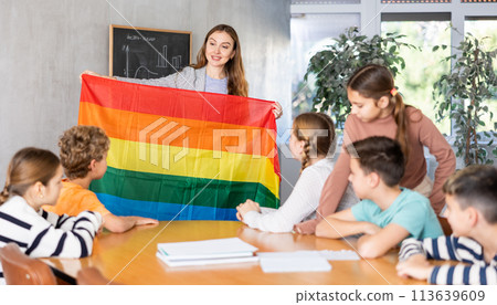 Teacher showing transgender flag to group of schoolchildren 113639609