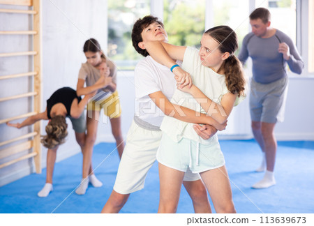 Boy and girl practicing self-defense techniques Boy and girl practicing self-defense techniques 113639673