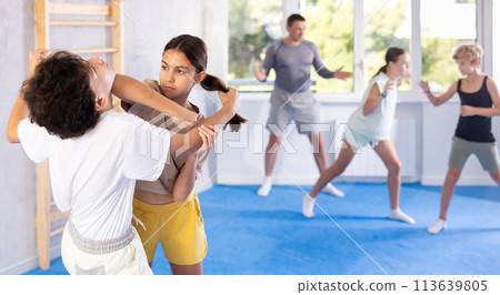 Boy and girl practicing self-defense techniques 113639805