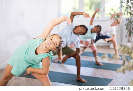 Young girl doing pilates in group of children Young girl doing pilates in group of children 113639806