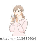 A smiling woman operating a smartphone 113639904