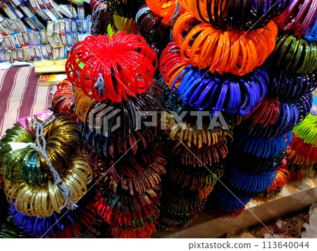 A bundle of colorful bangles on sale along the roadside in an Indian village A bundle of colorful bangles on sale along the roadside in an Indian village 113640044